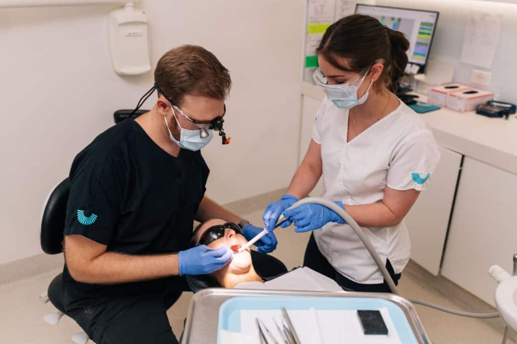 Dentists looking at patient